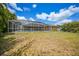 Spacious backyard featuring a large pool enclosure, perfect for outdoor enjoyment at 657 Hartford Nw Dr, Port Charlotte, FL 33952