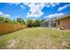 This backyard features a large pool enclosure and a wood fence at 657 Hartford Nw Dr, Port Charlotte, FL 33952