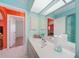 Bright bathroom with a large vanity, a decorative mirror, and a separate toilet area at 657 Hartford Nw Dr, Port Charlotte, FL 33952