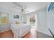 Comfortable bedroom with access to the pool, features white walls and hardwood floors at 657 Hartford Nw Dr, Port Charlotte, FL 33952