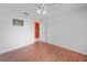 This spacious bedroom features wood floors and a ceiling fan with a light at 657 Hartford Nw Dr, Port Charlotte, FL 33952