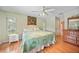 Bedroom with hardwood floors, a white bed, and a dresser with a mirror at 657 Hartford Nw Dr, Port Charlotte, FL 33952