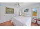 Cozy bedroom with white bedding, light blue walls, and a window view at 657 Hartford Nw Dr, Port Charlotte, FL 33952