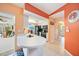 Well-lit kitchen with breakfast bar, leading to the dining area, and view of the patio at 657 Hartford Nw Dr, Port Charlotte, FL 33952