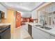 Open kitchen with white cabinets, tiled backsplash, and stainless steel appliances at 657 Hartford Nw Dr, Port Charlotte, FL 33952