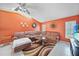 Spacious living room featuring a brown sofa, colorful rug, and accent wall decor at 657 Hartford Nw Dr, Port Charlotte, FL 33952