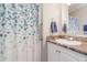 Bathroom features a single sink, marble countertop, and patterned shower curtain at 714 Fairmount Dr, North Port, FL 34287