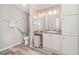 Clean and bright bathroom with a granite countertop, cabinets, and accessible toilet at 714 Fairmount Dr, North Port, FL 34287