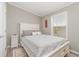 Neutral bedroom with a white bed frame, gray walls, and a window with natural light at 714 Fairmount Dr, North Port, FL 34287