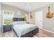 Cozy bedroom featuring hardwood floors, a ceiling fan, and two windows at 714 Fairmount Dr, North Port, FL 34287