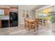 Open-concept kitchen and dining area with guitar decor and a sliding door to the patio at 714 Fairmount Dr, North Port, FL 34287