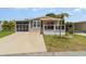 Charming single-story home with a screened-in porch, porch, and well-maintained lawn at 714 Fairmount Dr, North Port, FL 34287