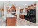 Well-lit kitchen with stainless steel appliances, hardwood cabinets and marble countertops at 714 Fairmount Dr, North Port, FL 34287