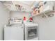 Modern laundry room featuring white wire shelving and washer/dryer units at 714 Fairmount Dr, North Port, FL 34287