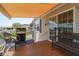 Cozy outdoor patio featuring a grill, comfortable seating, and a retractable awning for shade at 714 Fairmount Dr, North Port, FL 34287