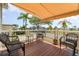 Inviting covered porch featuring comfortable seating, perfect for enjoying the outdoor views at 714 Fairmount Dr, North Port, FL 34287