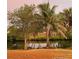 Landscaped backyard featuring mature trees with a water view, creating a private outdoor retreat at 719 Ellicott Nw Cir, Port Charlotte, FL 33952