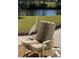 Outdoor chair with a garden view and a great egret perched by the pond, adding a touch of elegance at 719 Ellicott Nw Cir, Port Charlotte, FL 33952