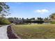 Serene backyard view featuring a tiki hut on a private canal for relaxing waterfront enjoyment at 719 Ellicott Nw Cir, Port Charlotte, FL 33952