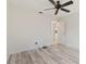 Bedroom features laminate flooring, ceiling fan and an adjacent closet at 719 Ellicott Nw Cir, Port Charlotte, FL 33952