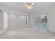 Bedroom featuring carpeted floors, ceiling fan and views of the pool at 719 Ellicott Nw Cir, Port Charlotte, FL 33952