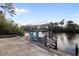 This wooden dock includes a boat lift and serene water views with seating for relaxation at 719 Ellicott Nw Cir, Port Charlotte, FL 33952