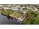Waterfront home with a screened lanai, boat dock, and tiki hut, offering a relaxing outdoor experience at 719 Ellicott Nw Cir, Port Charlotte, FL 33952