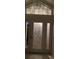Elegant white front door adorned with a herons and foliage etched in glass, and sidelight panels at 719 Ellicott Nw Cir, Port Charlotte, FL 33952