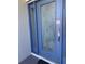 Elegant blue front door adorned with a herons and foliage etched in glass, and a sidelight panel at 719 Ellicott Nw Cir, Port Charlotte, FL 33952