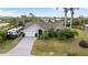 Ranch-style house with landscaped front yard and lengthy driveway. Note the RV on site at 719 Ellicott Nw Cir, Port Charlotte, FL 33952