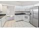 Bright kitchen with white cabinets and stainless steel appliances at 719 Ellicott Nw Cir, Port Charlotte, FL 33952
