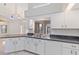 Bright kitchen featuring white cabinetry, granite counters, and stainless steel appliances at 719 Ellicott Nw Cir, Port Charlotte, FL 33952