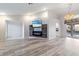 Open-concept living room with stylish floors, fireplace, and access to the backyard pool area at 719 Ellicott Nw Cir, Port Charlotte, FL 33952