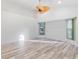 Spacious living room with plank flooring and neutral colored walls at 719 Ellicott Nw Cir, Port Charlotte, FL 33952