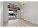 Bright living room with wood floors, slider to pool, and ample light at 719 Ellicott Nw Cir, Port Charlotte, FL 33952