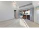 Spacious main bedroom featuring plush carpeting and slider to lanai at 719 Ellicott Nw Cir, Port Charlotte, FL 33952