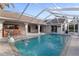 Sparkling pool featuring a fountain, dolphin statue, and screened enclosure for outdoor enjoyment at 719 Ellicott Nw Cir, Port Charlotte, FL 33952