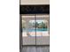 Sliding glass doors provide a view of the pool area, perfect for enjoying the Florida sunshine at 719 Ellicott Nw Cir, Port Charlotte, FL 33952