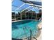 Inviting screened-in pool with crystal-clear water, offering a refreshing and private outdoor oasis at 719 Ellicott Nw Cir, Port Charlotte, FL 33952