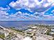 Beautiful aerial view showcasing the marina, waterfront condos, and vibrant coastal community under a bright, cloudy sky at 740 W Virginia Ave, Punta Gorda, FL 33950