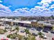 Beautiful aerial view of a sunny neighborhood with palm trees, businesses and a bright blue, cloudy sky at 740 W Virginia Ave, Punta Gorda, FL 33950