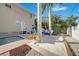 The backyard features a sand area, hammock, and small splash pool with red brick and tropical palms at 740 W Virginia Ave, Punta Gorda, FL 33950