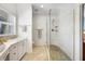 Bright bathroom with white marble shower featuring river rock flooring and glass door at 740 W Virginia Ave, Punta Gorda, FL 33950