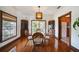 Dining room features hardwood floors, light fixture, and windows for ample natural light at 740 W Virginia Ave, Punta Gorda, FL 33950