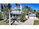 Two story home with neutral colored siding, metal roof and detached garage at 740 W Virginia Ave, Punta Gorda, FL 33950