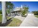 Charming two-story home with a spacious front porch, mature trees, and a detached garage at 740 W Virginia Ave, Punta Gorda, FL 33950