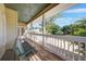 Cozy front porch with a hanging swing, creating a relaxing and inviting outdoor space with scenic views at 740 W Virginia Ave, Punta Gorda, FL 33950