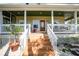 Inviting front porch with wood stairs, white railings, and charming decor, offering a warm welcome to the home at 740 W Virginia Ave, Punta Gorda, FL 33950
