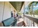 Spacious front porch with a swing and chairs, perfect for relaxing and enjoying the outdoor view at 740 W Virginia Ave, Punta Gorda, FL 33950