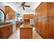 Well-equipped kitchen with custom wood cabinets, granite countertops, and a center island, perfect for culinary enthusiasts at 740 W Virginia Ave, Punta Gorda, FL 33950